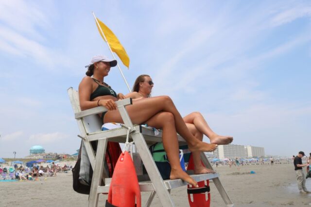 Solo female traveler walking safely along Ocean City NJ shoreline
